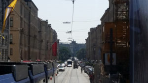 trams in the middle of the street; cars, bikes, and pedestrians have their own lanes